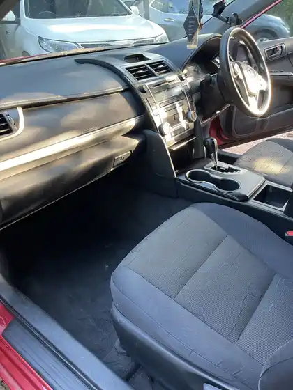 The same Camry interior after detailing, with clean upholstery, dashboard and console