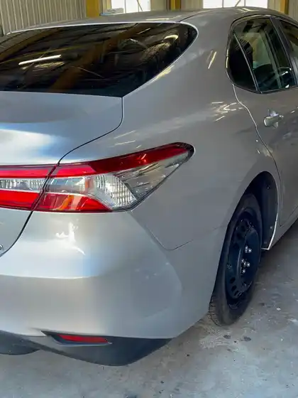 The same silver Toyota Camry Hybrid with the rear end rebuilt, showing an even boot gap, a fitted bumper and matched silver paint