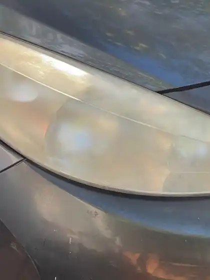 The same headlight after restoration, the lens clear enough to see the reflector and bulb housing behind it