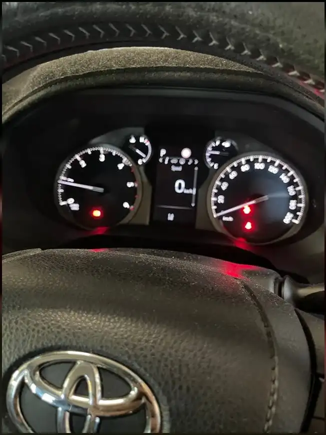 Toyota steering wheel and illuminated dashboard inside a vehicle in Darwin