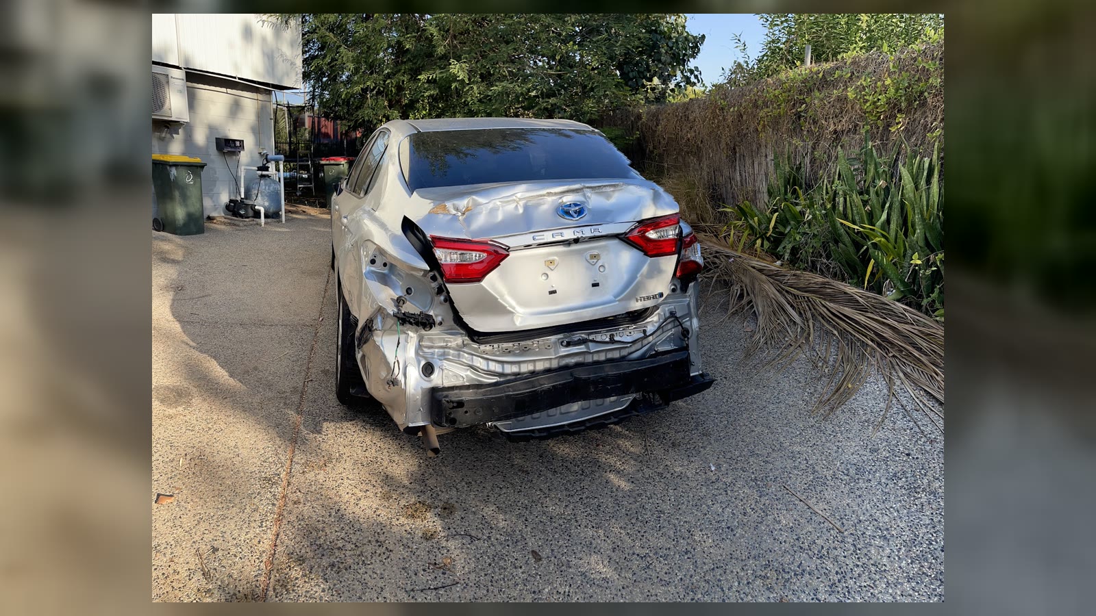 Silver Toyota Camry with rear quarter panel and bumper damage before repair at Auto Body Fix Darwin
